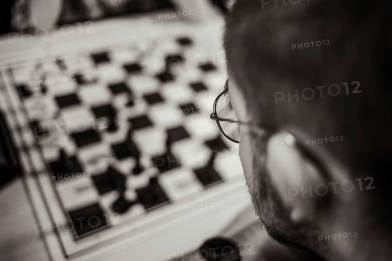 Chess player at the chessboard thinking about his next move, Leoben, Styria, Austria, Europe