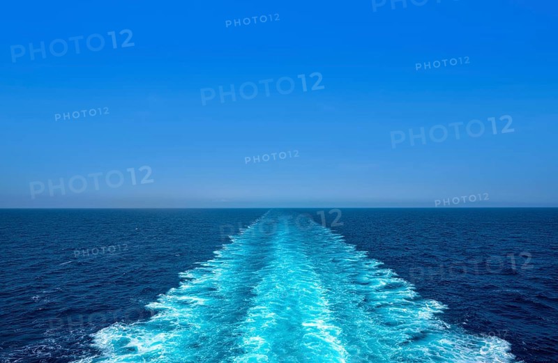 Boat wake ferry cruise wash foam in blue ocean sea