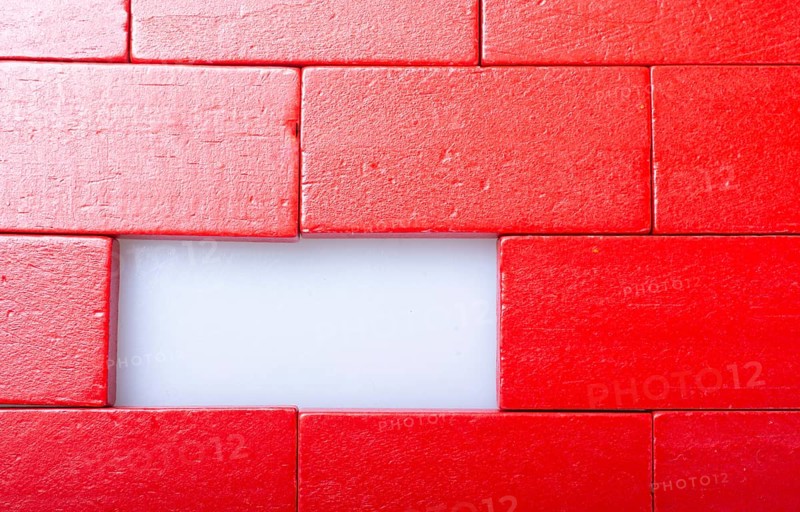 Red color domino blocks placed on a white background