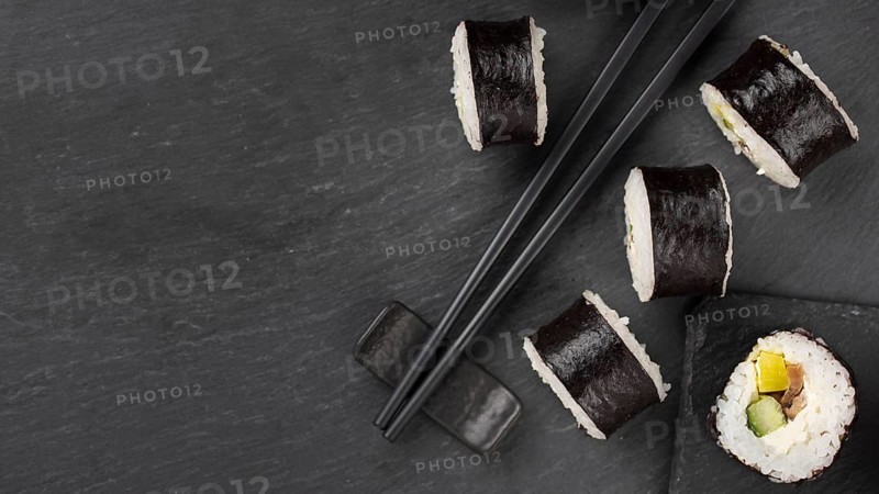 Sushi rolls with chopsticks copy space