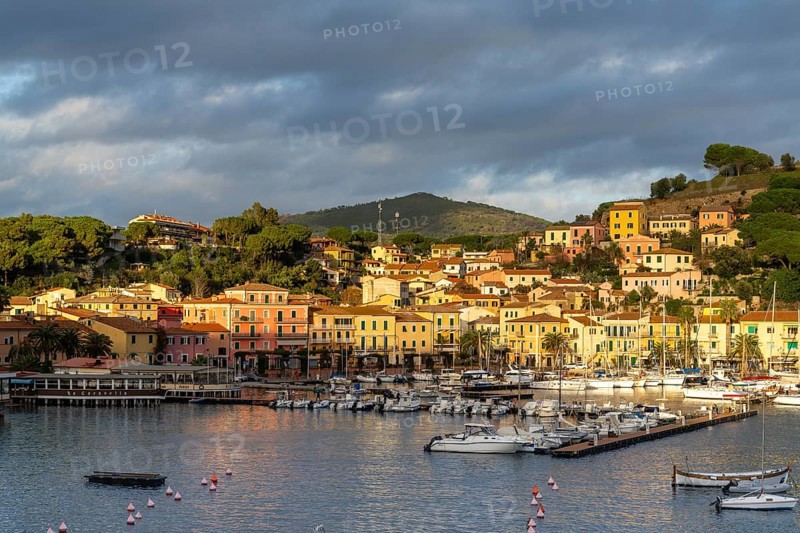 Porto Azzurro, Italy, 12 November, 2023: view of the harbor marina and Porto Azzurro village on Elba Island at sunset, Europe