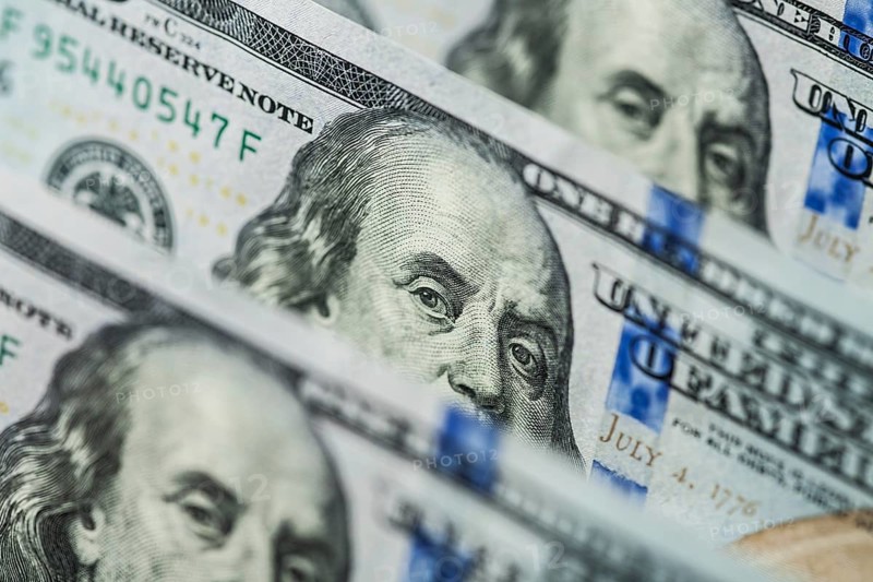 Hundred dollars bills standing in a row. Selective focus