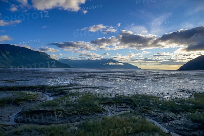 Vast coastal landscape at sunset with calm water under a cloudy sky, Turnagain Arm, Alaska, USA, North America