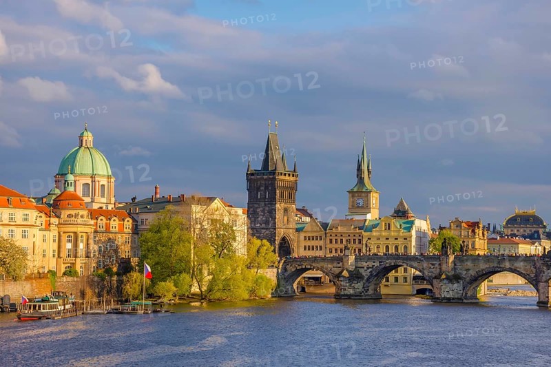 Charles Bridge (Karluv Most) on Vltava river and Old Town Bridge Tower, famous tourist destination in Prague, Czech Republic (Czechia), at sunset