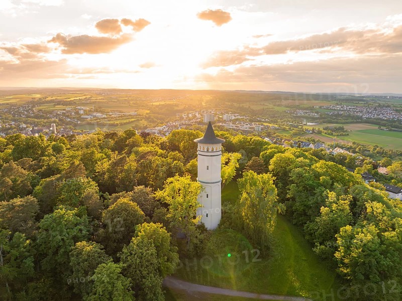 A tower rises in the sunset above the green forest and the vast countryside, Engelberg Tower, Leonberg, Germany, Europe