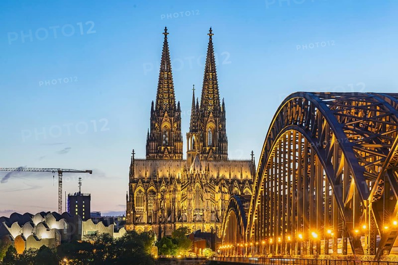 Cologne Cathedral, illuminated in the evening. Hohenzollern Bridge, railway bridge over the Rhine. City view of Cologne, North Rhine-Westphalia, Germany, Europe