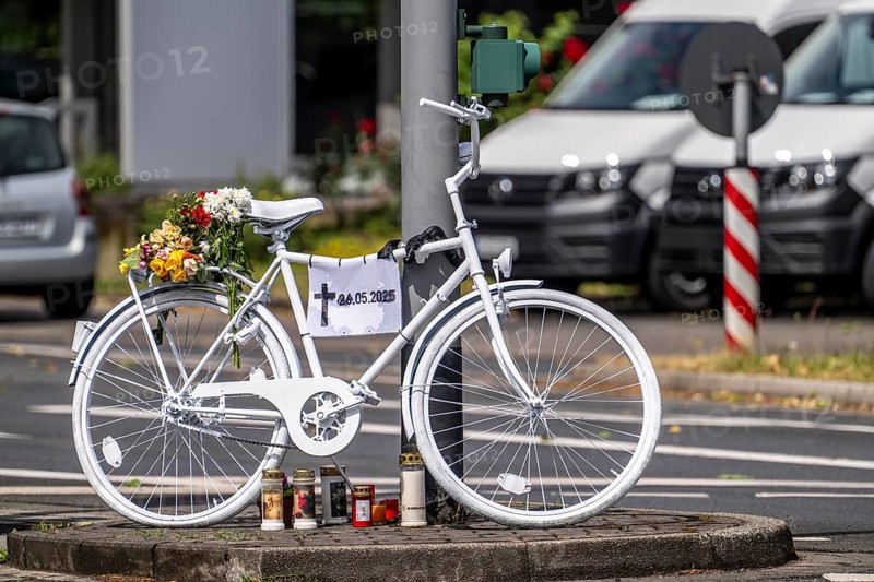 A ghost bike at the scene of an accident where a cyclist was run over by a lorry two days earlier and died, the white-painted bike is intended to serve as a memorial at the junction to commemorate the accident and remind people to drive more carefully, Essen-Kray, North Rhine-Westphalia, Germany, Europe