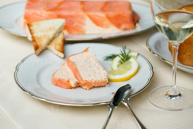 Southern German cuisine, salmon trout terrine arranged on a plate, salmon terrine with trout fillets, fish dish, salmon fillets, smoked salmon, starter, fine dining, Sunday crockery with gold rim, grandma's service, lemons, dill, fish cutlery, toast, food photography, studio, Germany, Europe