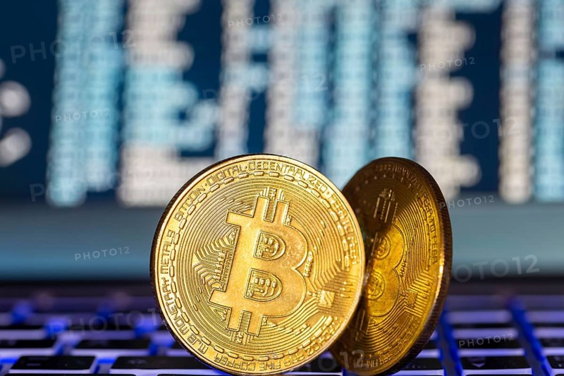 Symbolic bitcoins on a laptop