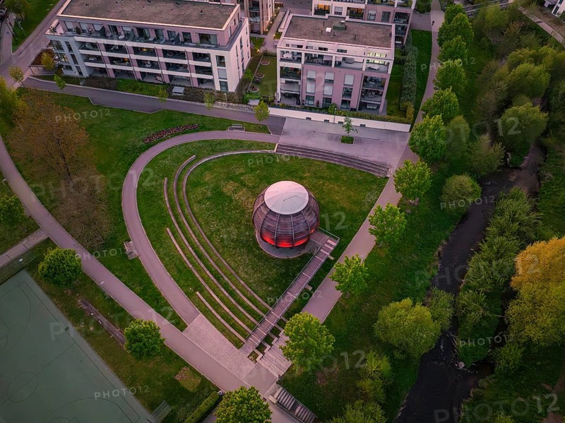 Aerial view of a modern wooden construction in the park with trees and surrounding buildings at dusk, Forstkugel, Nagold Black Forest, Germany, Europe
