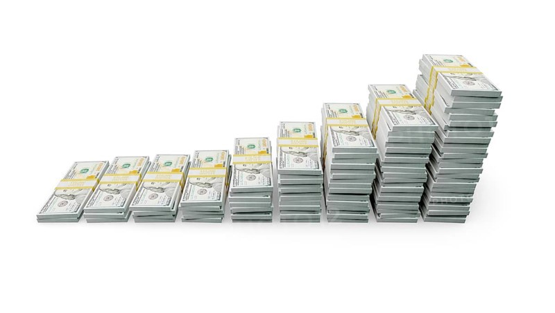 Rising stacks of money representing financial growth and wealth increase isolated on a white background