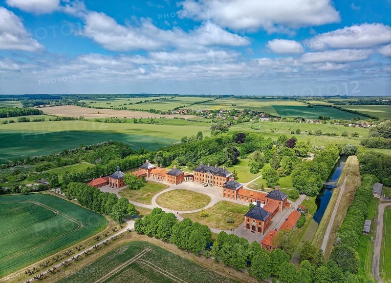 Aerial view of Bothmer Castle, a baroque three-winged complex. The castle stands on a rectangular island, surrounded by a ravine that was used for drainage. Klütz, Mecklenburg-Western Pomerania, Germany, Europe