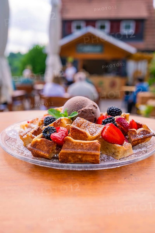 Waffles with ice cream and berries served outside on a terrace, Cafehäusle Calw, Black Forest, Germany, Europe