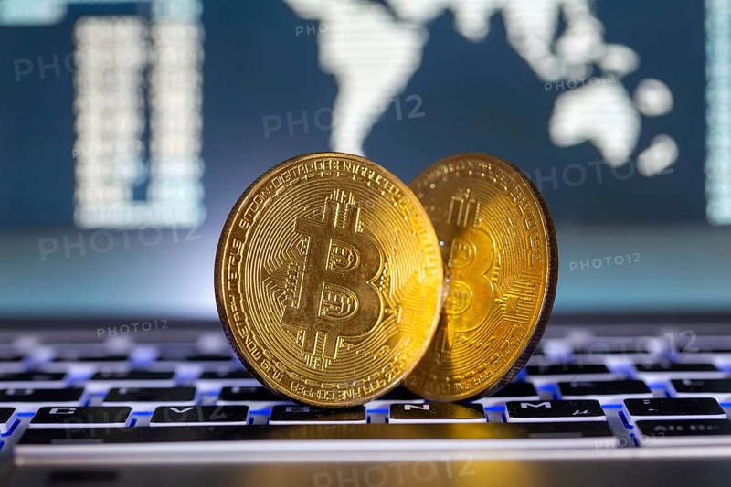Symbolic bitcoins on a laptop