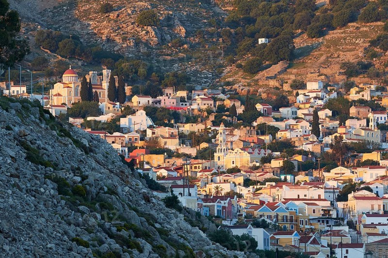 A picturesque hilltop village with traditional stone houses and a summery atmosphere, Symi Town, Symi, Dodecanese, Greek Islands, Greece, Europe