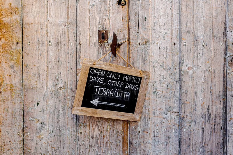 Wooden door with small slate plaque in the old town of Santanyi, Majorca, Balearic Islands, Spain, Europe