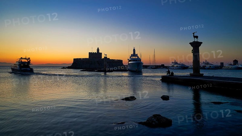 Harbour view at sunset with boats and a fortress, calm sea and evening atmosphere, sunrise, dawn, Fort of Saint Nikolaos, Mandraki Harbour, Rhodes Town, Rhodes, Dodecanese, Greek Islands, Greece, Europe