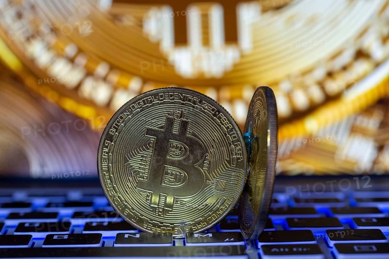 Symbolic bitcoins on a laptop