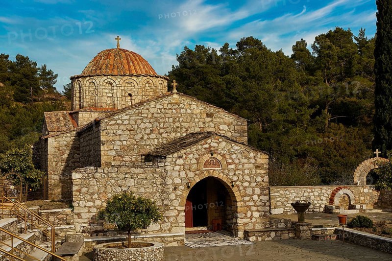 Historic stone church under a blue sky surrounded by trees, Thari Monastery, Moni Thari, near Gadouras Reservoir, lonely mountain region, Rhodes, Dodecanese, Greek Islands, Greece, Europe