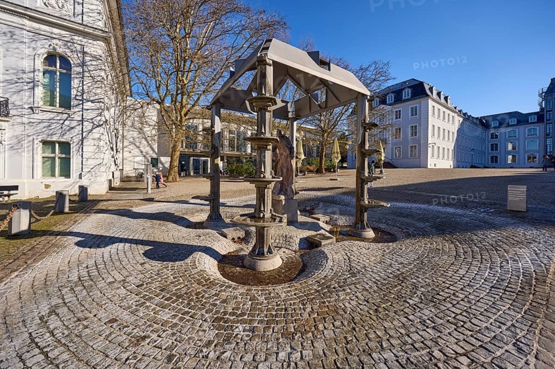 Fountain, sculptor Gottfried Leo Böhm, trees, square, cobblestones, Saarbrücken Castle, blue sky, cloudless, Schlossplatz, Saarbrücken, state capital, regional association Saarbrücken, Saarland, Germany, Europe