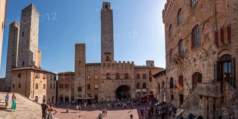 SAN GIMIGNANO, ITALY, SEPTEMBER 20, 2023, Main square Piazza del Duomo in San Gimignano with its famous palace towers, Rognosa tower and Theater dei Leggieri in the center, Italy, Europe