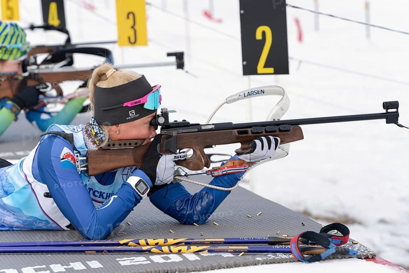 Kamchatka sportswoman biathlete Petrunova Kseniya rifle shooting in prone position. Biathlete in shooting range of Open regional youth biathlon competitions East Cup. Kamchatka, Russia, Apr 12, 2019, Europe