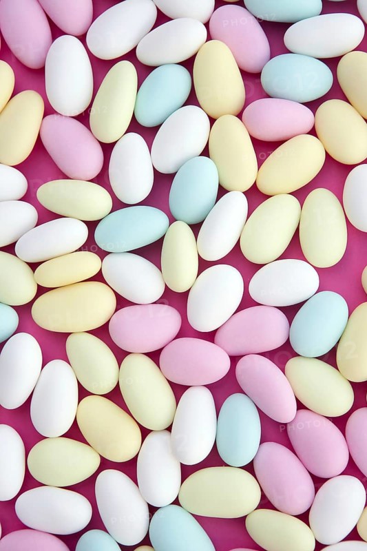 Sugared almond sweet candy pastel colorful on soft pink
