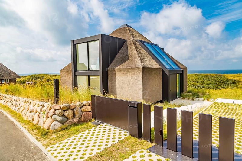 Controversial modern thatched-roof villa of the Kersig estate in the dunes, Hörnum, Sylt