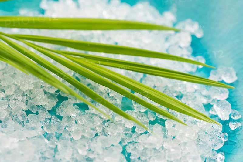 Bath salt and palm leaf