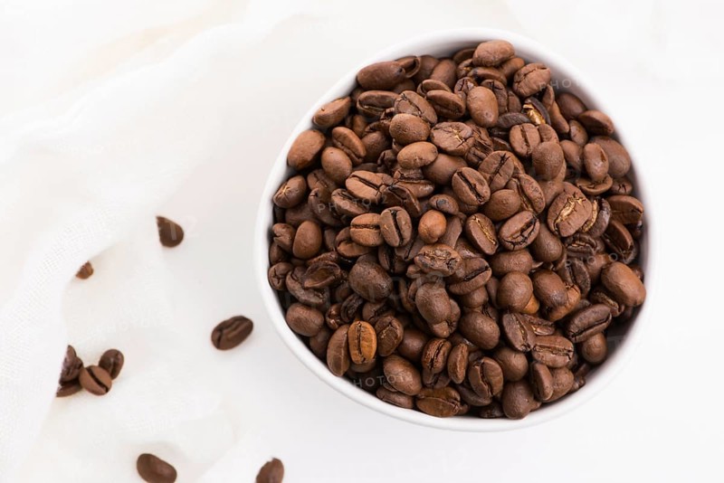 Bowl of caffee beans on a white background