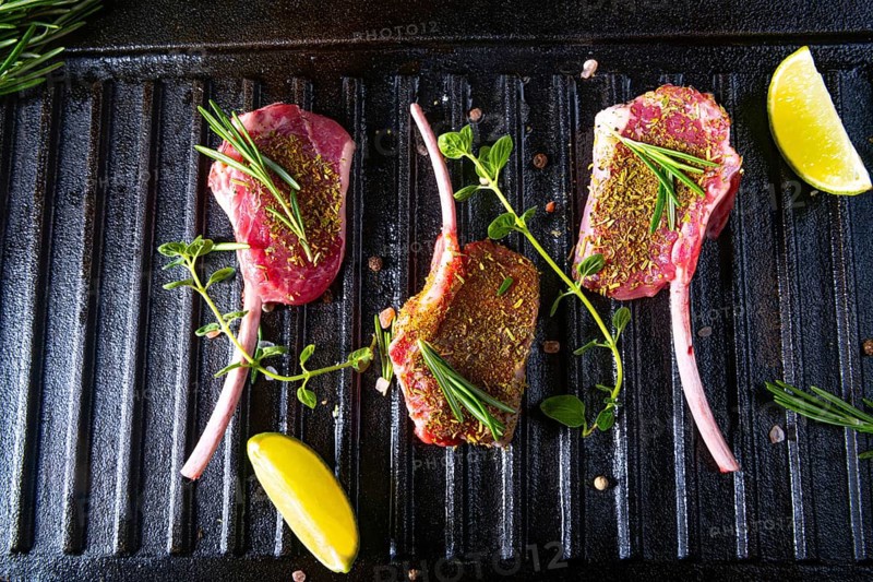 Seasoned and herb-marinated raw lamb chops