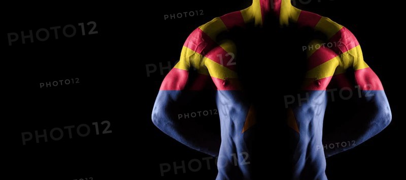 Arizona flag on muscled male torso with abs, Arizona bodybuilding concept, black background