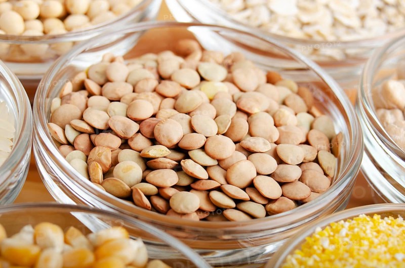 Lentils closeup in glass bowl on wooden kitchen table, non-perishable, long shelf life food concept