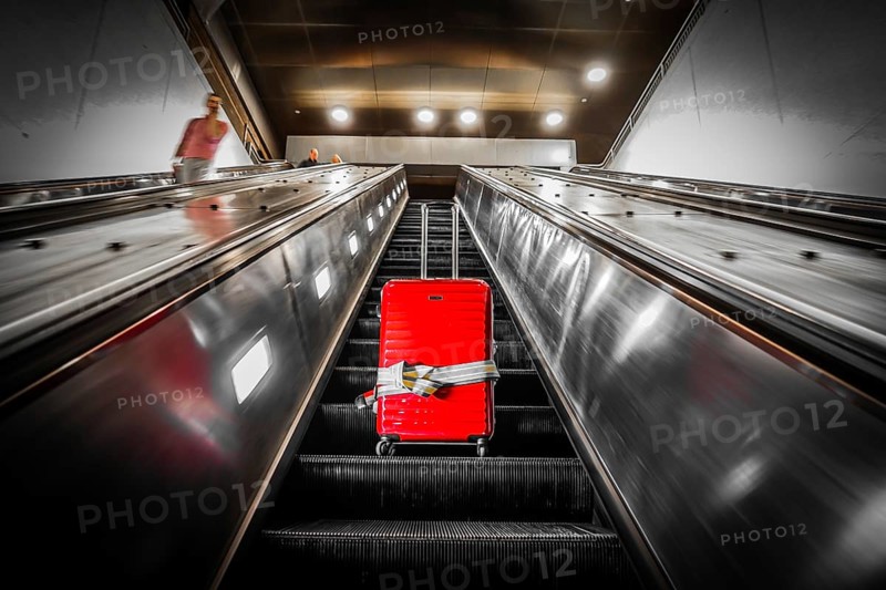 Escalator and suitcase. Shooting Location: New York, Manhattan