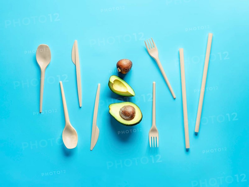 Avocado Seeds Biodegradable Single-Use Cutlery. Bioplastic - Great alternative to plastic disposable cutlery. Minimal concept on blue background