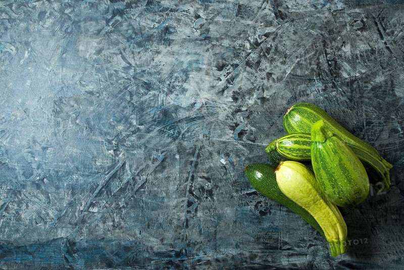 Vegetables on the background. Fresh vegetables (cucumbers, tomatoes, onions, garlic, dill, green beans) on a gray background. Top view. Copy space