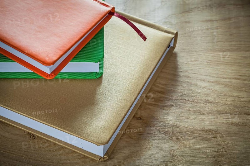 Stack of office notebooks on wooden board