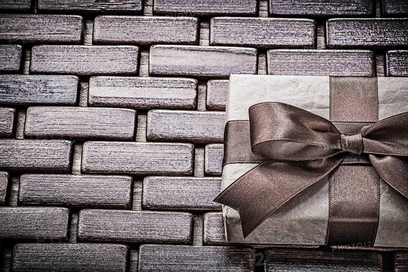 Present with ribbon on wooden mat horizontal view holidays concept