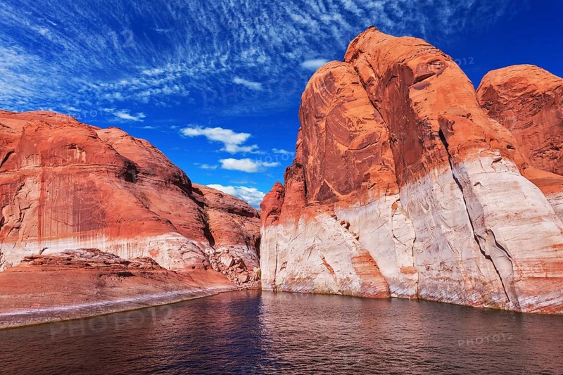 Lake Powell is surrounded by magnificent red hills. Walk on the boat at sunset. Scenic huge artificial water basin of the Colorado River, USA, North America