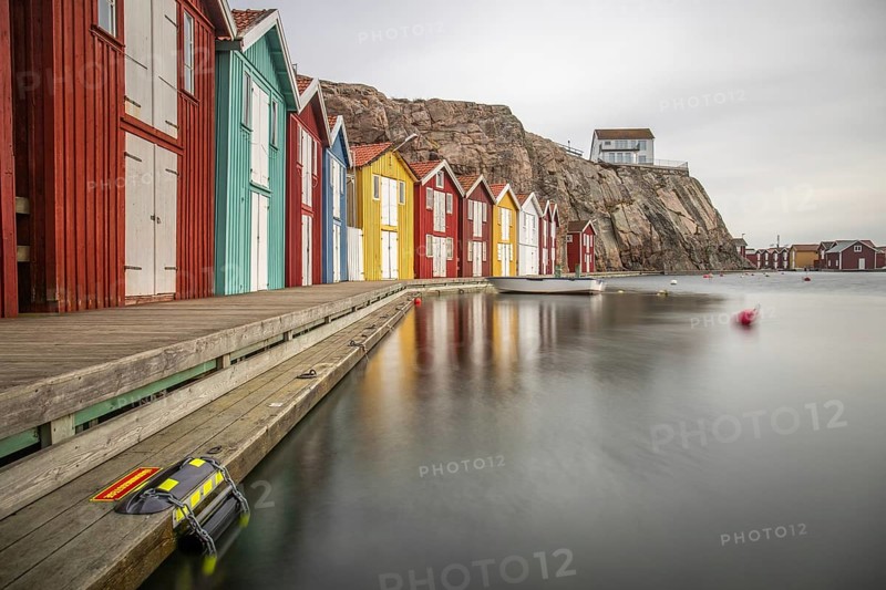 Small colourful houses by the sea. Typical houses in Sweden for the coastal landscape. Crab fishing and storage in a narrow harbour. Smögen, Smögenbryggan, Sweden, Europe