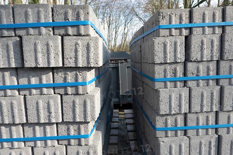 Concrete bricks, secured with blue straps, are being transported on a truck, ready for construction or landscaping projects, Bottrop, NRW, Germany, Europe
