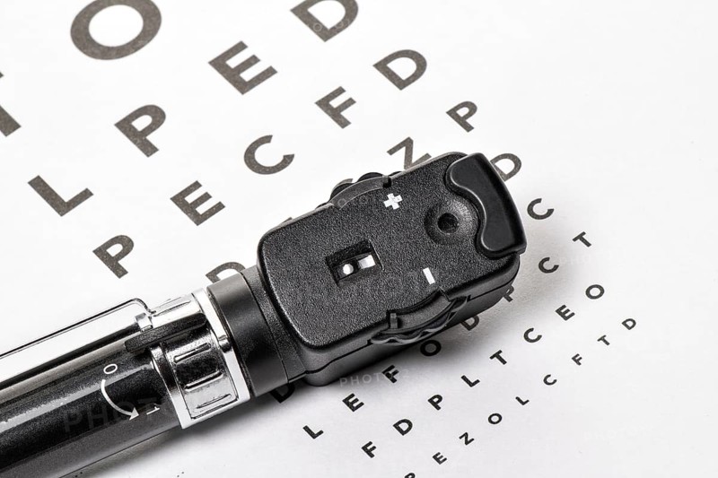 The ophthalmoscope is located on an eye test, with a white background