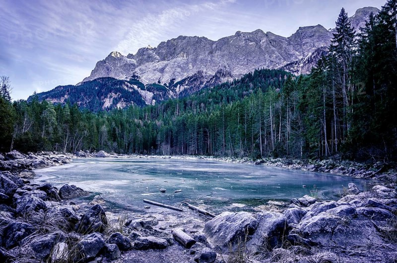 Winter scenery with an alpine frozen lake surrounded by the German Alps, near the municipality Grainau, district Garmisch-Partenkirchen, Bavaria, Germany, Europe