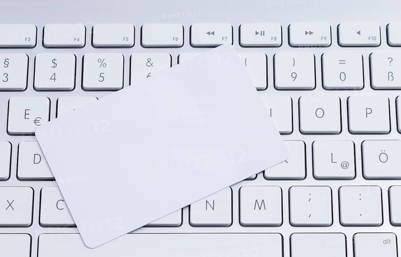 White keyboard with a blank white pastille card