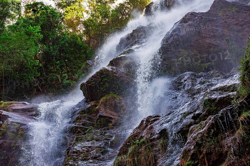 Water splashing through the rocks and forest forming a beautiful waterfall in Minas Gerais, Brazil, South America