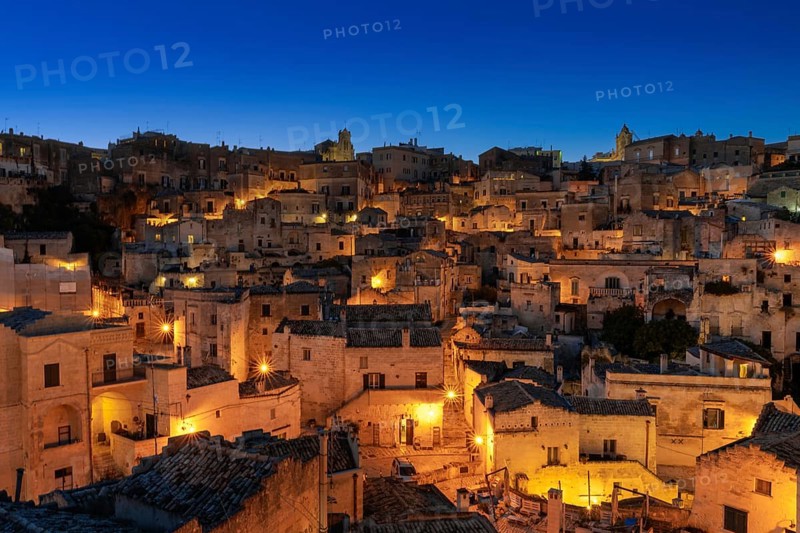 Matera, Italy, 26 November, 2023: view of the old town of Matera after sunset with the lights coming on, Europe