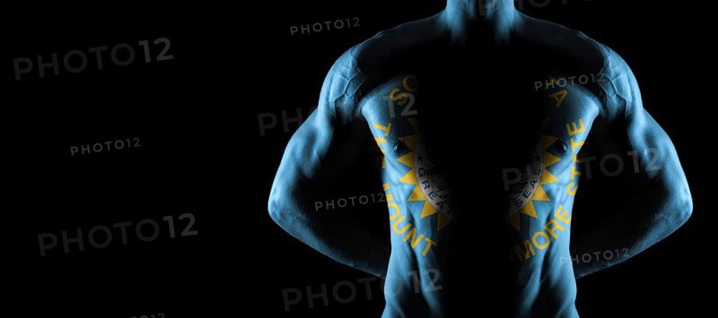 South Dakota flag on muscled male torso with abs, South Dakota bodybuilding concept, black background