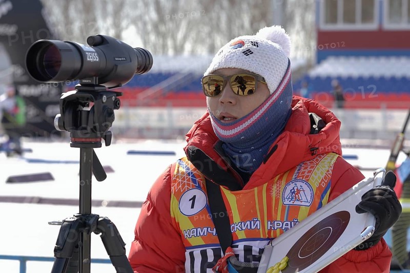 Coach of South Korea biathlon team instructs biathletes at shooting range of biathlon stadium during Junior biathlon competitions East of Cup. Kamchatka Peninsula, Russian Far East, April 14, 2019