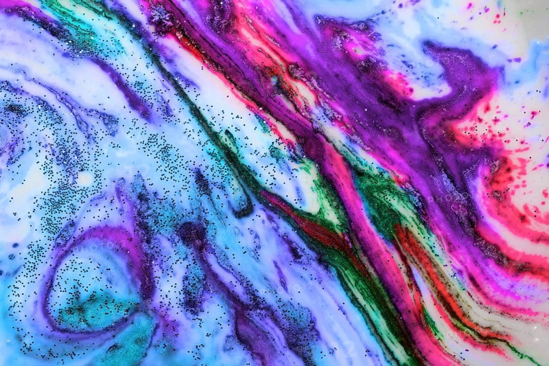 Multicoloured background of bright colours covered with gold sparkles