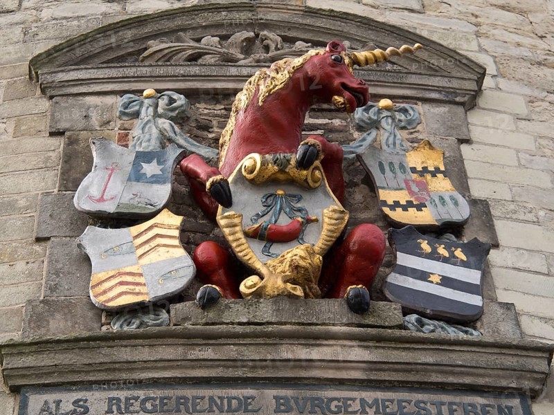 Stone relief with a red unicorn and several colourful coats of arms, hoorn, ijsselmeer, netherlands
